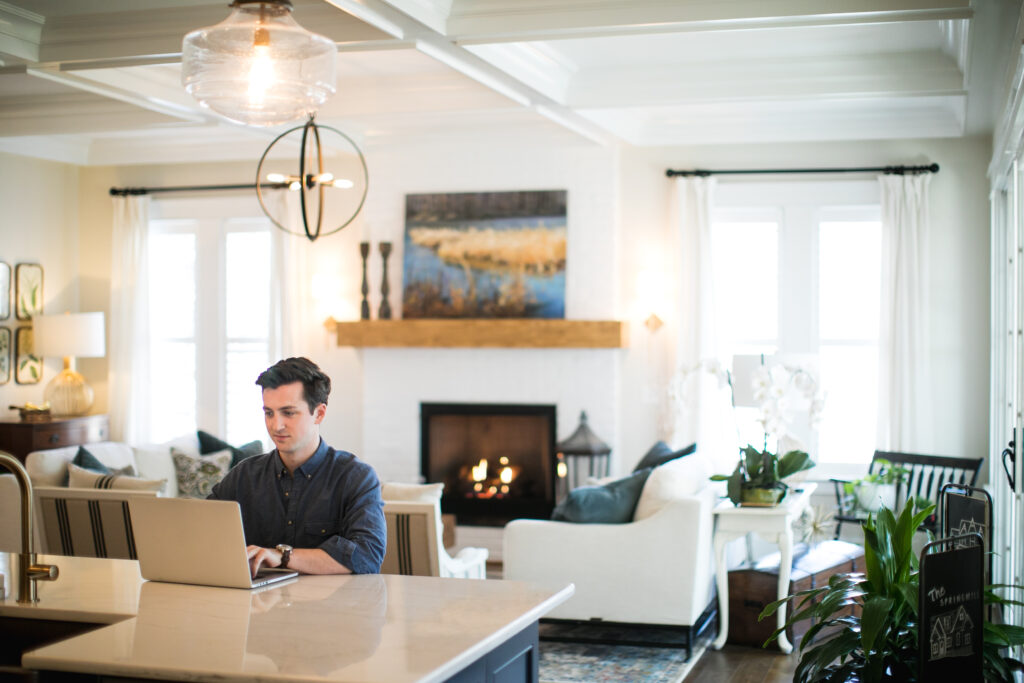 man researching on laptop in home