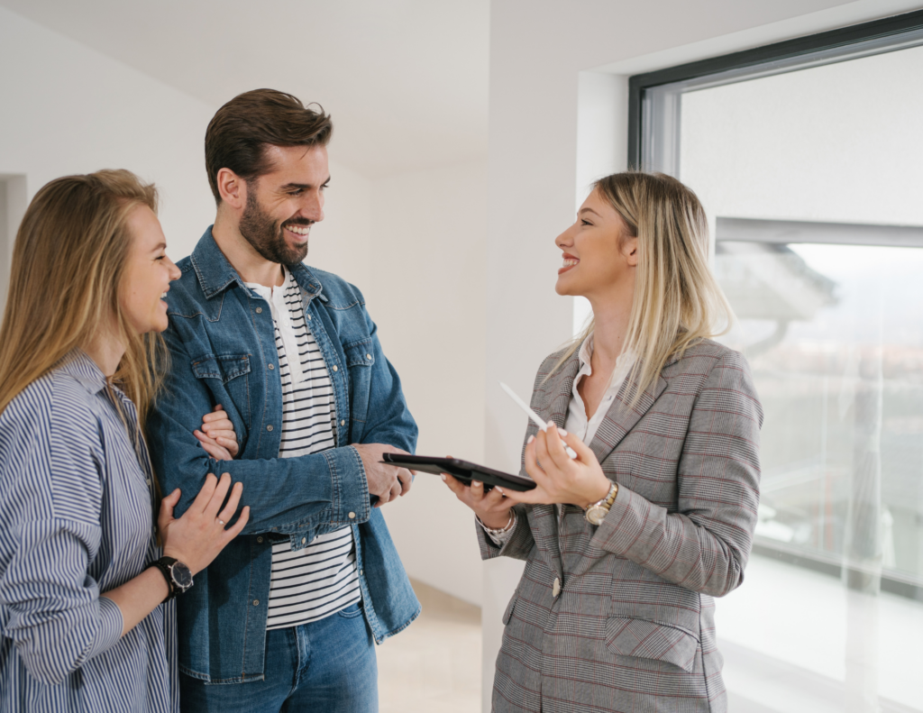 smiling real estate agent with young couple