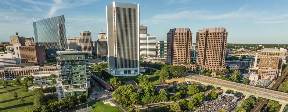 An aerial view of a river and a small city with several tall buildings