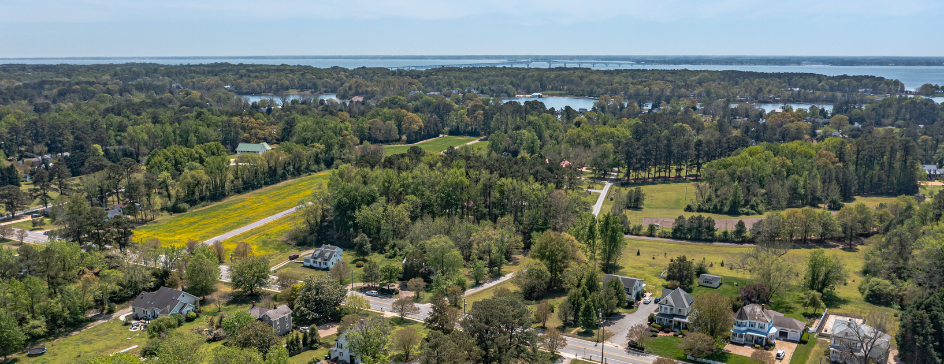 Aerial of homes, land, and a river
