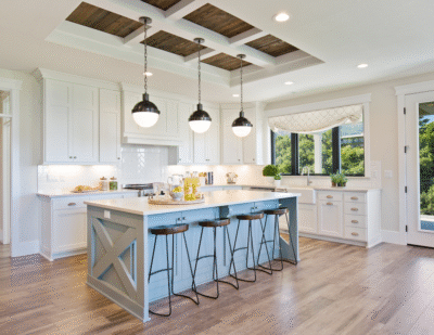 Home kitchen with a blue island and a coffered ceiling.