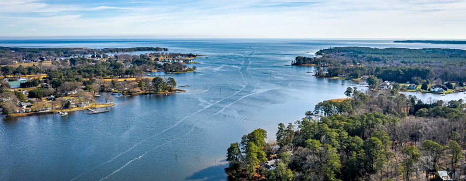An aerial view of a river opening into a bay